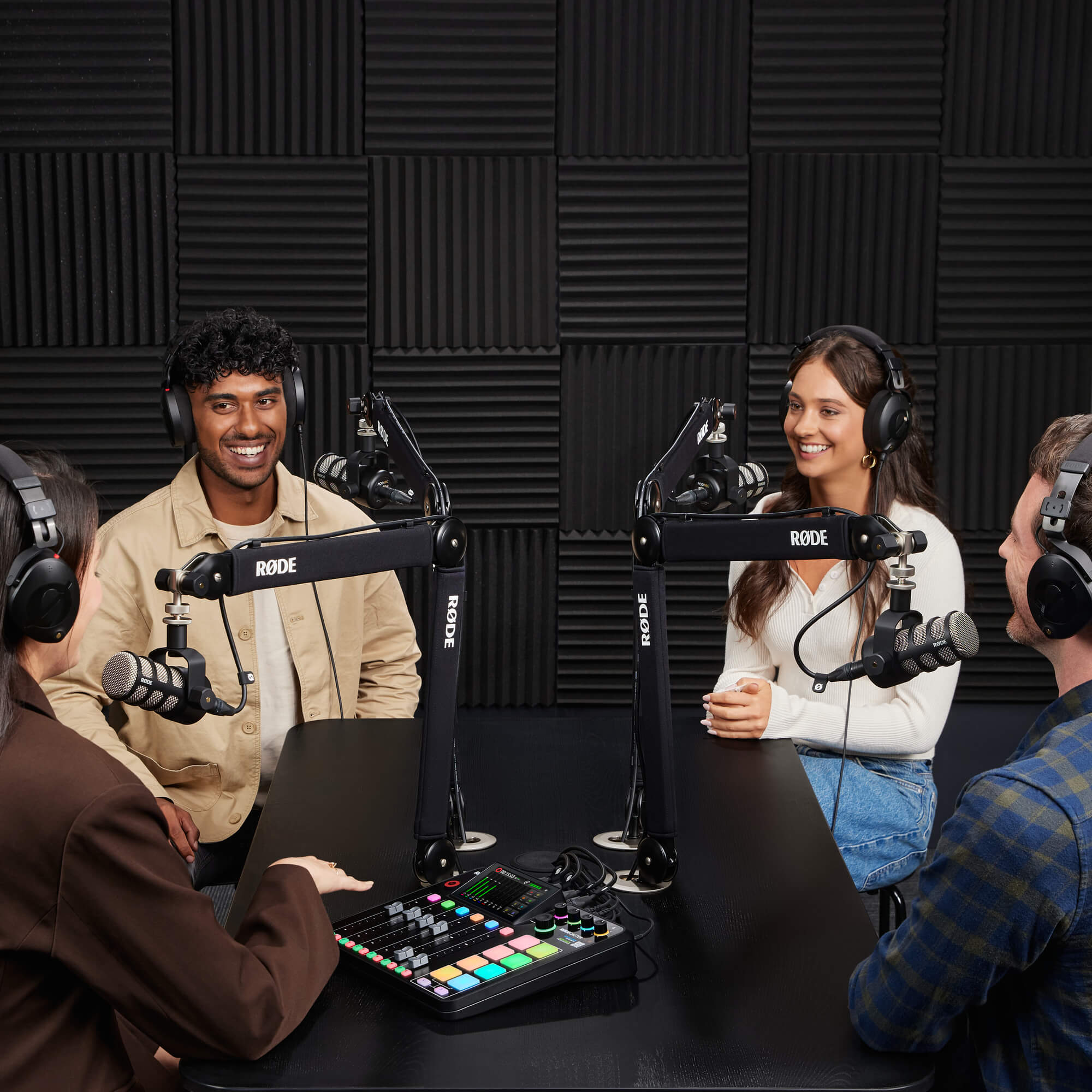 IMAGE: Four people in a podcast setting