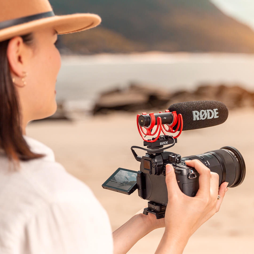 girl outside with videomic on a camera