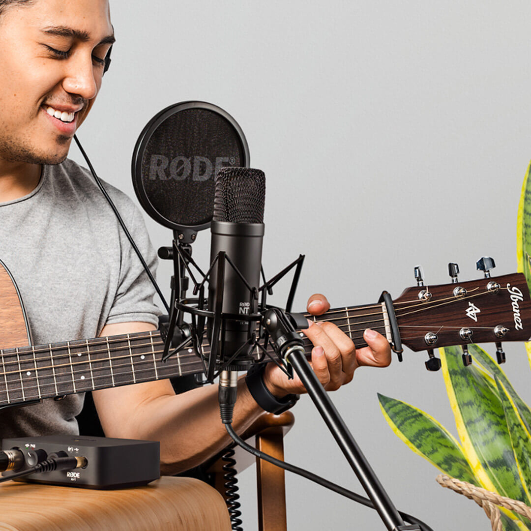 man playing guitar with NT1 on shock mount