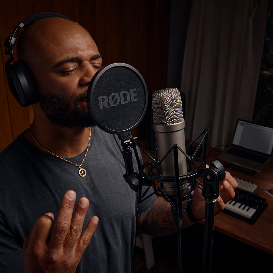 man singing into microphone with popfilter