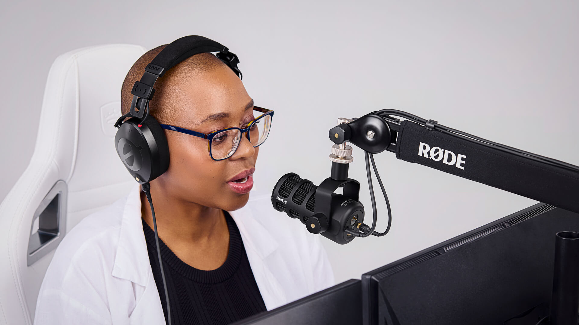 Girl wearing NTH-100 speaking into PodMic USB on PSA1+