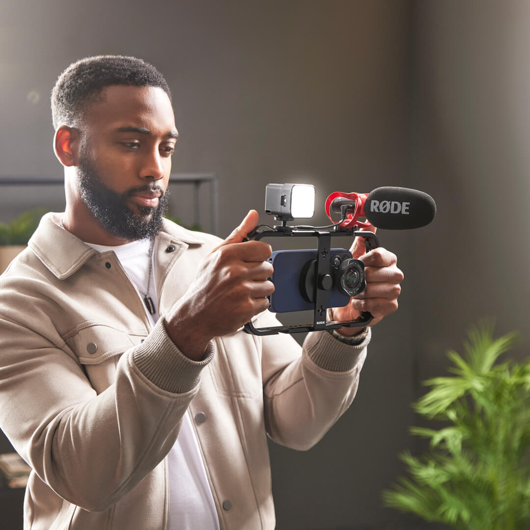 Man filming on mobile with Phone Cage