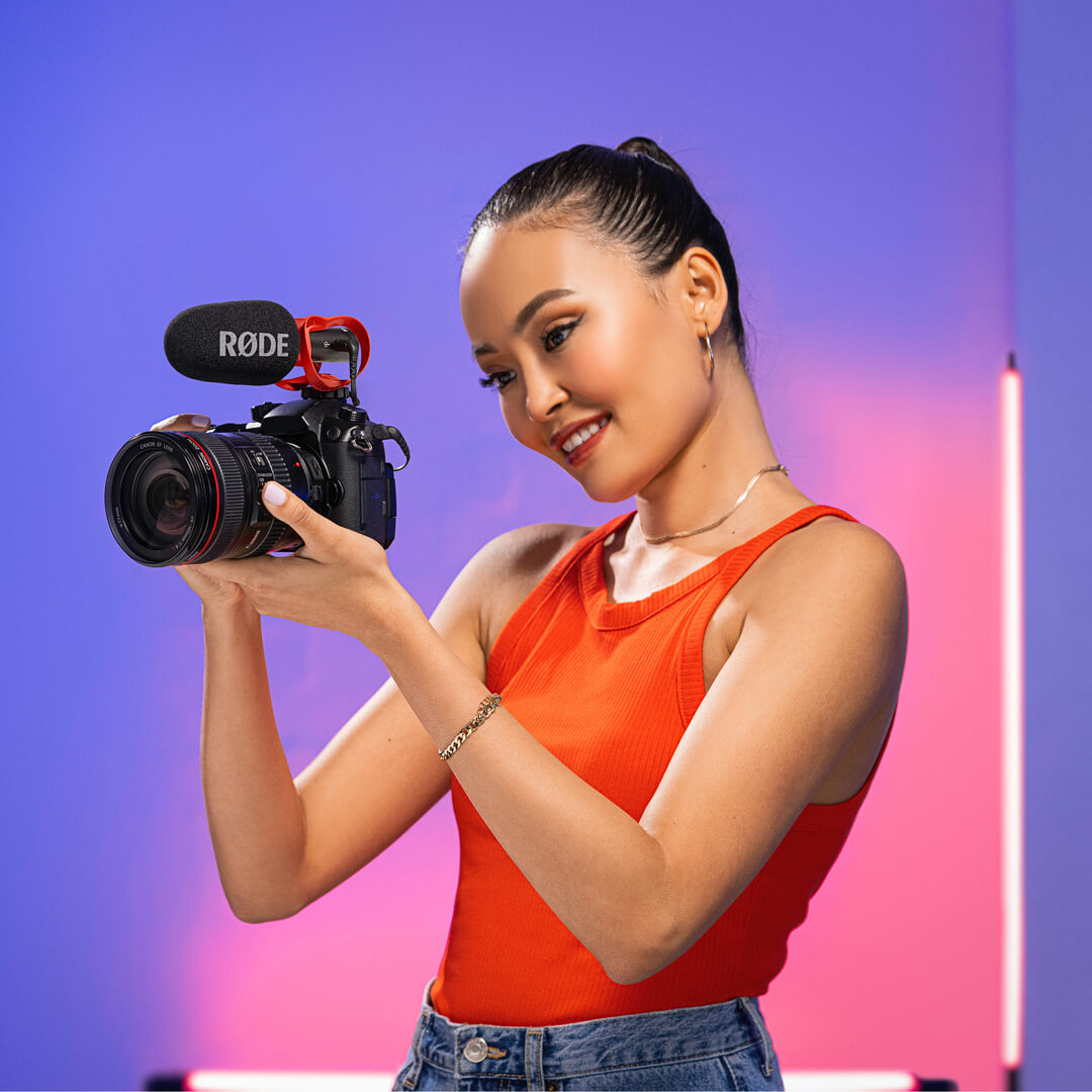 Girl holding camera with VideoMic GO II mounted