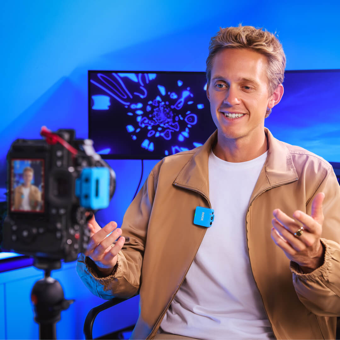 Man using blue Wireless GO (Gen 3) camera setup at desk