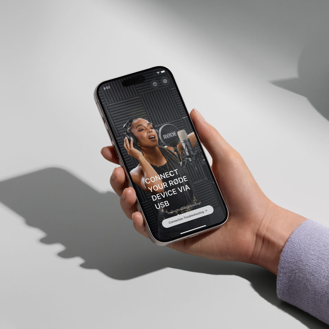 Hand holding iPhone showing RØDE Central