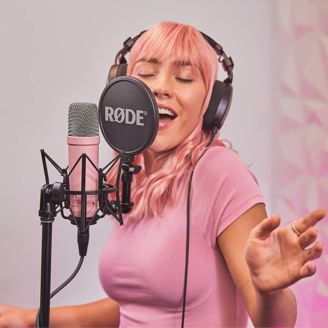 Girl recording vocals with pink NT1 Signature Series