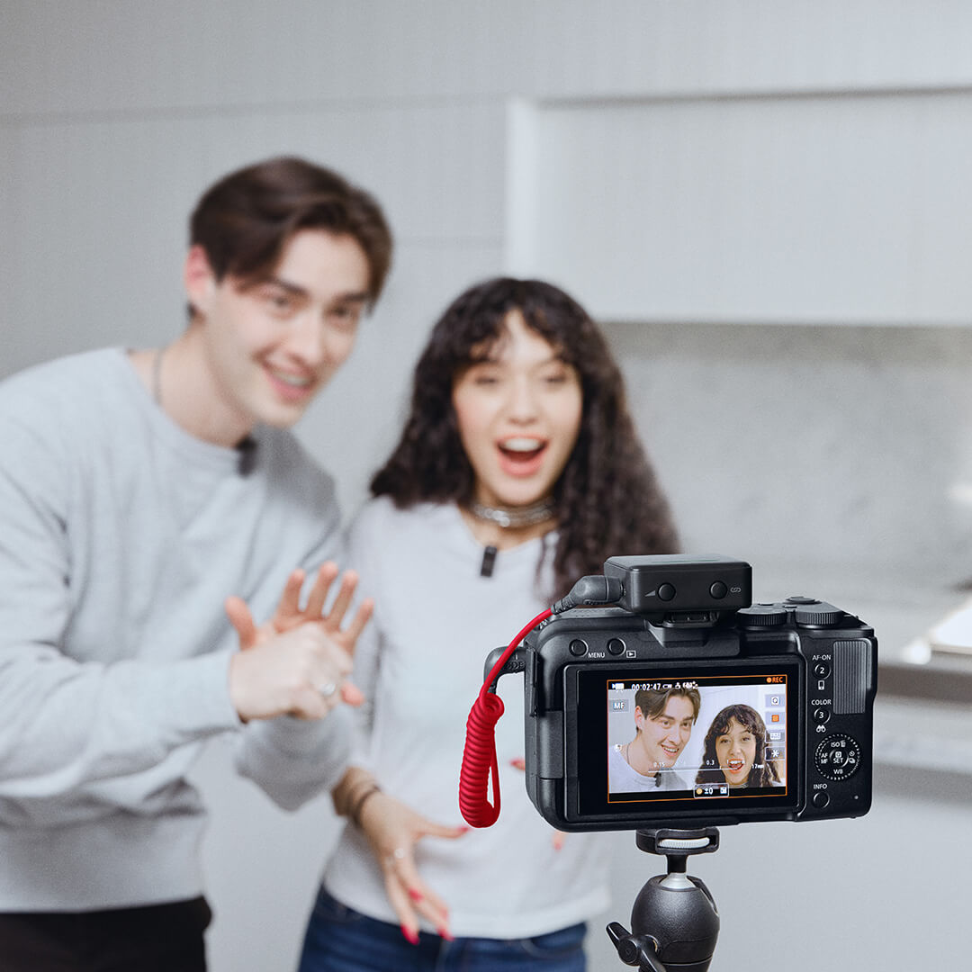 Wireless Micro Camera Receiver on a camera with two people in shot